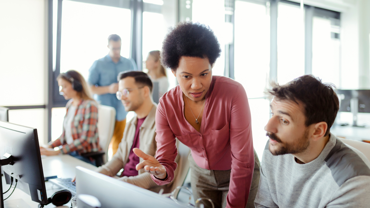 Group of people talking over a computer screen