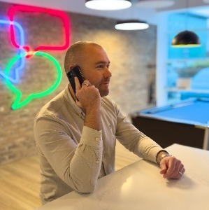 Recruitment Consultant on phone smiling